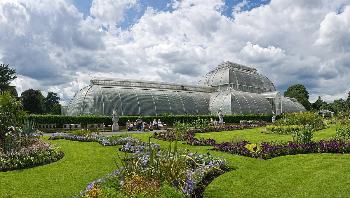 A view across the gardens to the Palm House in Kew Gardens , in London, England.